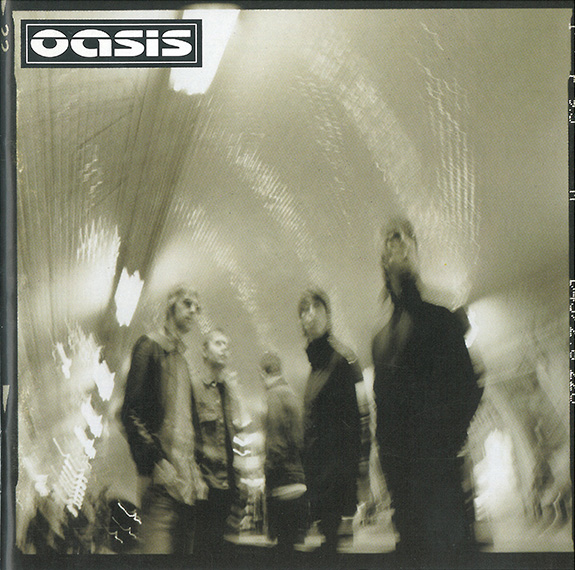 The cover artwork for 'Heathen Chemistry' showing a blurred, spinning image of the band in a lit tunnel